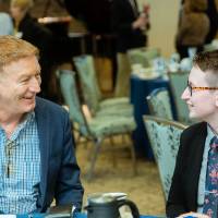 Two guests sitting and chatting at Scholarship Dinner 2019